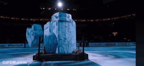 Large Ice Sculpture In Stadium With Coca-Cola And Verizon Ads GIF