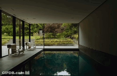 Large Indoor Swimming Pool Surrounded By Window GIF