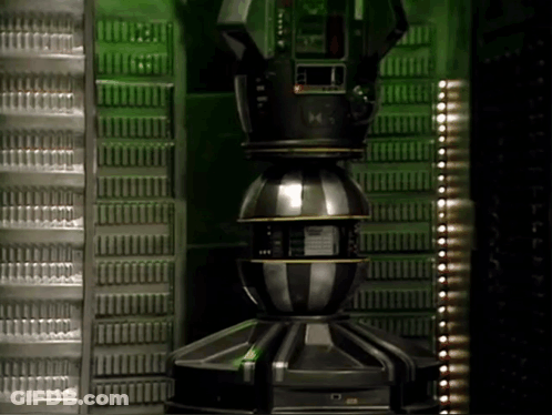 Large Metal Object With M On Green Wall GIF