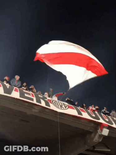Large Red White And Blue Flag Flying Over River Banner GIF