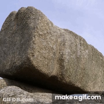 Large Rock In Front Of Banner GIF