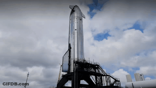 Large Rocket On Building With Clouds GIF