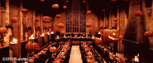 Large Room With Pumpkins Hanging From Ceiling GIF