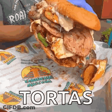 Large Sandwich With Toppings Saying Tortas GIF