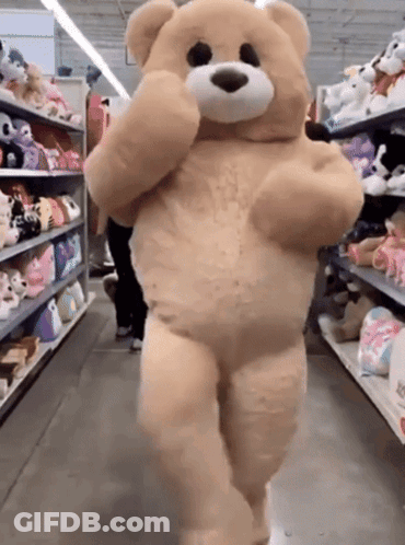Large Teddy Bear Walking In Store Aisle GIF