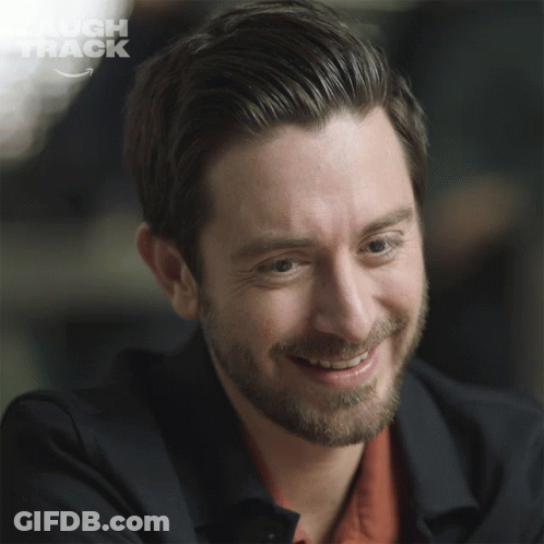 Laugh Track Logo Behind Man's Face GIF