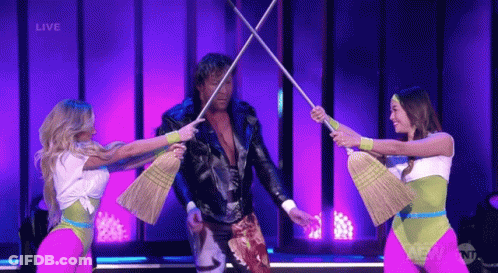Leather Jacket Man Surrounded By Women With Brooms GIF