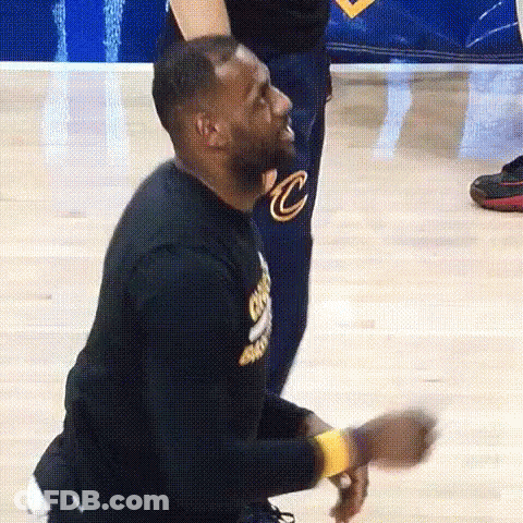 Lebron James Is Kneeling Down On The Court While A Man Stands Behind Him . GIF