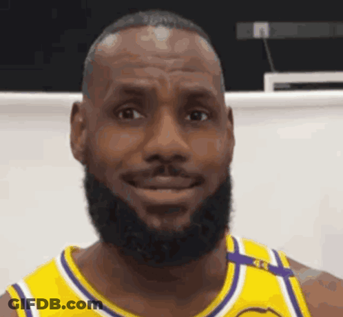 Lebron James Is Wearing A Yellow And Purple Jersey And Smiling . GIF