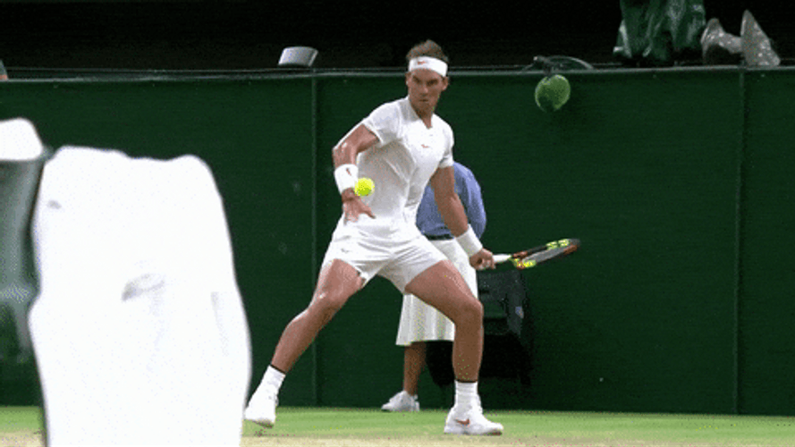 Left Handed Tennis Player Hitting Ball GIF