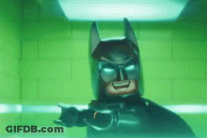 Lego Batman Standing In Front Of Green Brick Wall GIF