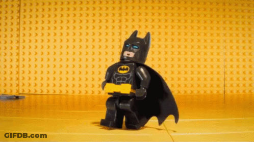 Lego Batman Standing In Front Of Yellow Bricks GIF