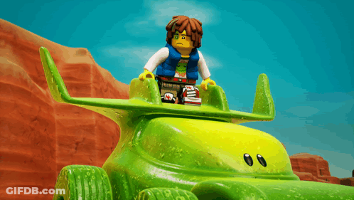Lego Figure Sitting On Green Toy Car GIF