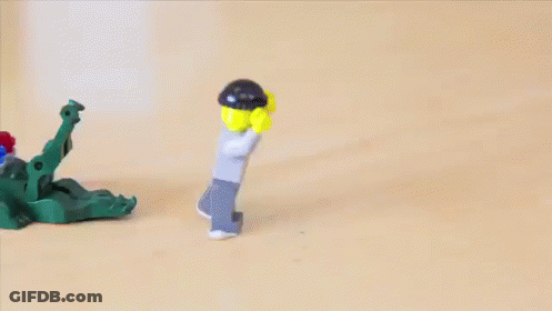 Lego Figure With Green Face Behind Fence GIF