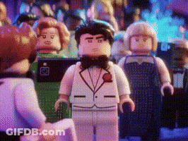 Lego Man In Tuxedo And Bow Tie Standing Before Group GIF