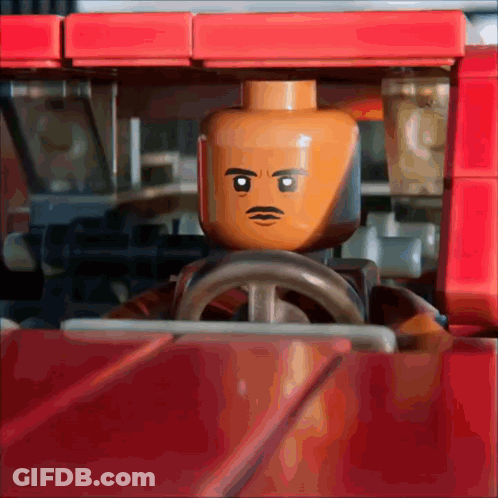 Lego Man With Mustache Driving Red Vehicle GIF
