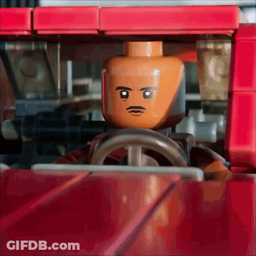 Lego Man With Mustache Driving Red Vehicle GIF