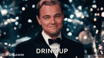 Leonardo DiCaprio In Tuxedo And Bow Tie Smiling At Christmas Tree GIF