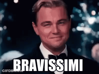 Leonardo Dicaprio Is Wearing A Tuxedo And Bow Tie And Smiling With The Words Bravissimi Written On His Face . GIF