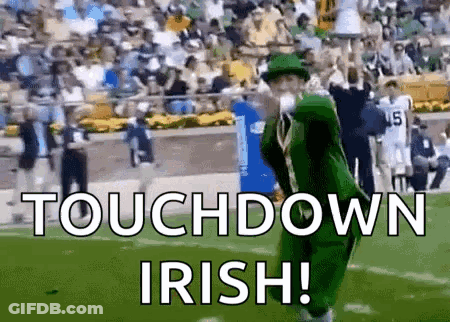 Leprechaun Blowing Kiss On Football Field With Crowd GIF