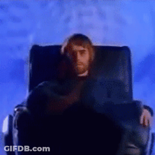 Liam Gallagher Sitting On Black Chair GIF