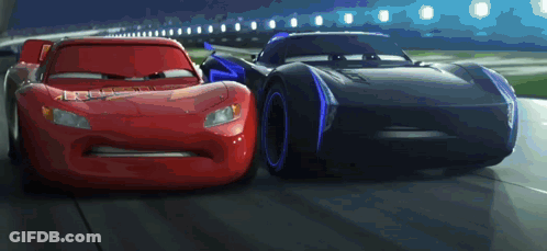 Lightning Mcqueen And Jackson Storm Racing On A Track GIF