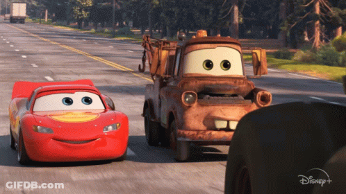 Lightning McQueen And Tow Truck Mater Driving Down Road GIF