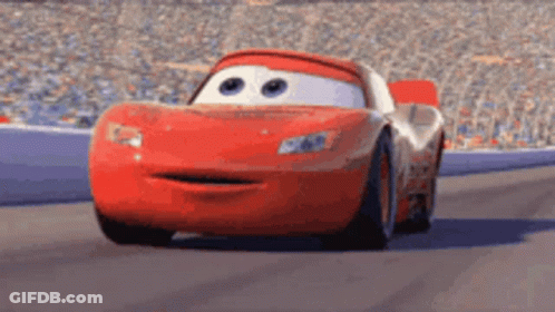 Lightning Mcqueen From Cars Is Driving Down A Race Track With His Mouth Open . GIF