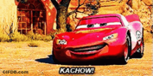 Lightning Mcqueen From Cars Is Smiling And Driving Down The Road . GIF