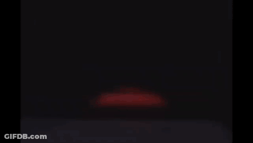 Lightning Mcqueen From Cars Is Smiling And Looking At The Camera In A Garage . GIF