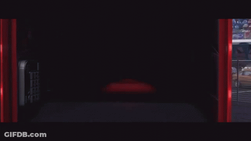 Lightning Mcqueen From The Movie Cars Is Smiling In A Garage GIF