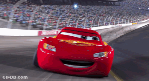 Lightning Mcqueen From The Movie Cars Is Smiling While Driving On A Race Track GIF