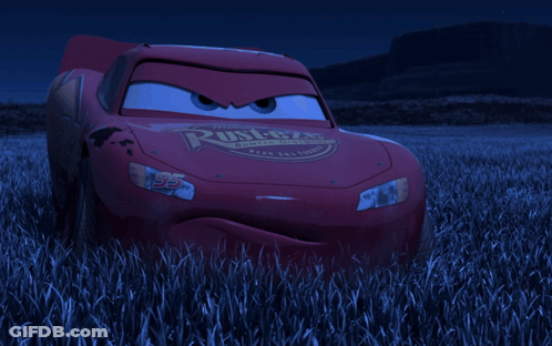 Lightning Mcqueen From The Movie Cars Is Standing In A Field Of Tall Grass GIF