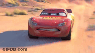 Lightning Mcqueen Is Driving Down A Dirt Road In The Desert . GIF