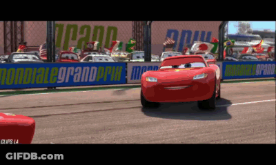 Lightning Mcqueen Is On A Race Track With A Sign That Says Mondiale Grand Prix GIF