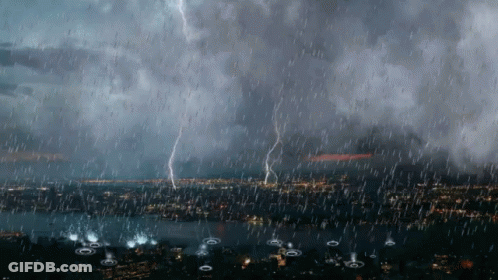 Lightning Strikes During A Heavy Rain Storm Over A City GIF
