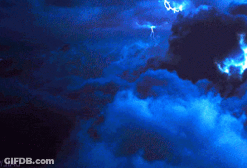 Lightning Strikes In A Dark Blue Sky With Yjiao Written On The Bottom Right GIF