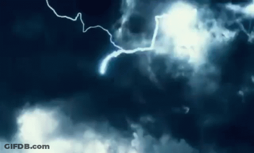 Lightning Strikes In A Dark Cloudy Sky At Night GIF