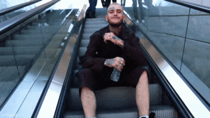 Lil Peep Sitting On Escalator GIF