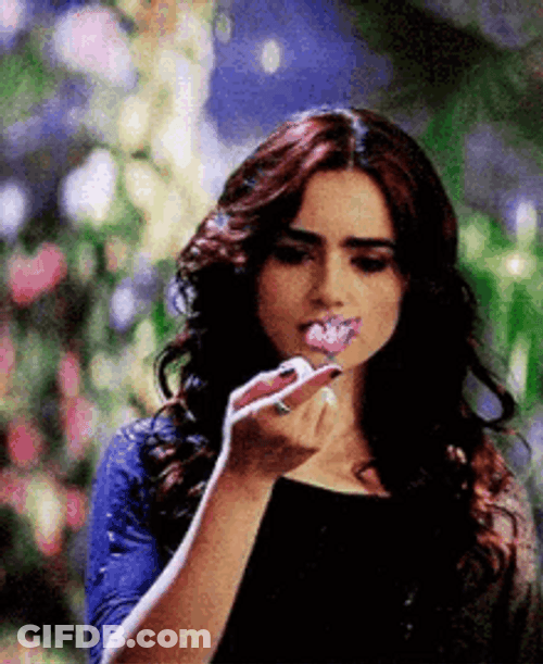 Lily Collins Looking At A Butterfly GIF