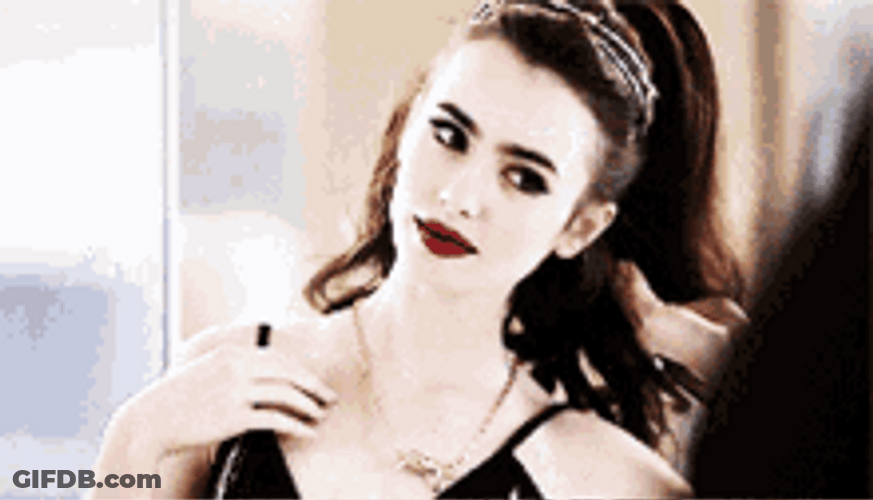 Lily Collins Posing For A Picture GIF