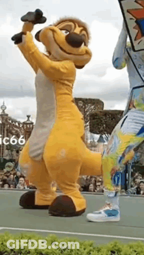 Lion King Mascot On Tennis Court With Microphone GIF