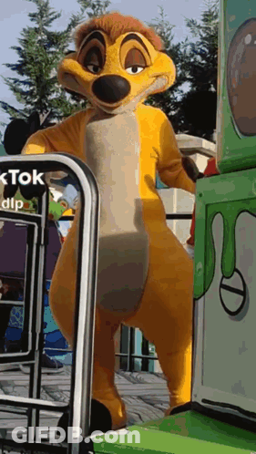 Lion King Mascot Standing In Front Of Green Box Saying Tok GIF