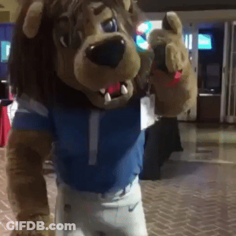 Lion Mascot In Blue Shirt And White Shorts GIF