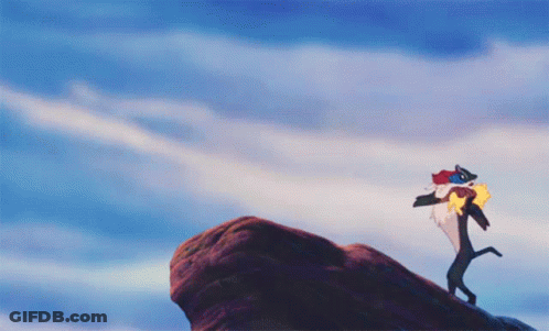 Lion Standing On Rock With Bird GIF