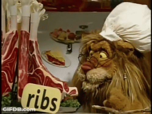 Lion With Glasses Looking At Ribs GIF