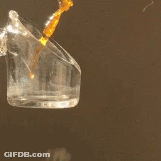Liquid Being Poured Into Clear Glass Container GIF