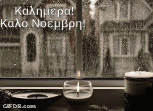 Lit Candle In Front Of Rainy Window GIF