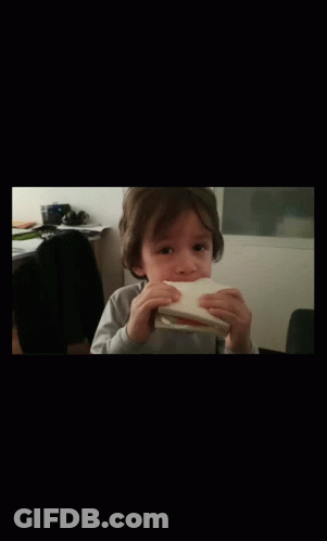 Little Boy Eating Bread With Hands GIF