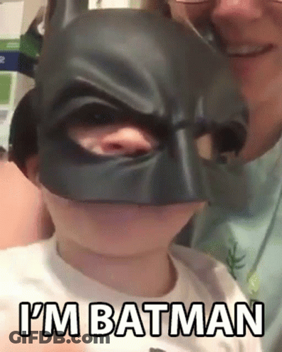 Little Boy In Batman Mask Held By Man GIF